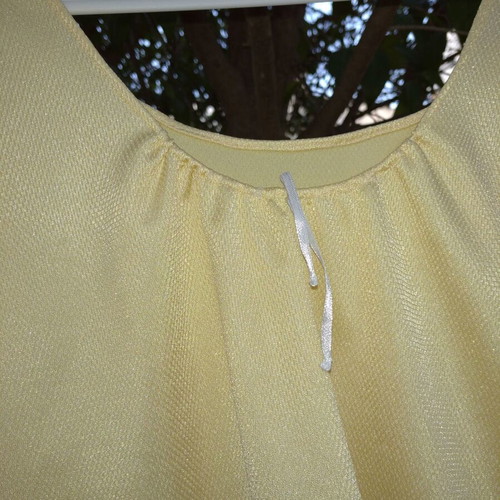 Yellow shiny blouse with white ribbon, loose fit