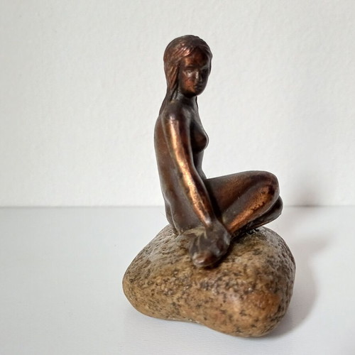 Vintage bronze Little Mermaid statue on natural stone used