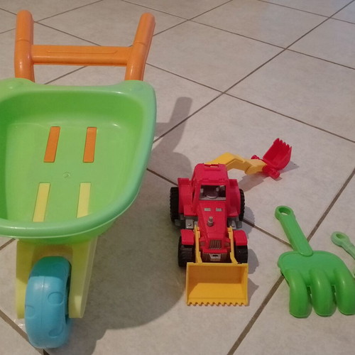 Beach toy set: plastic wheelbarrow, shovel, rake, small excavator