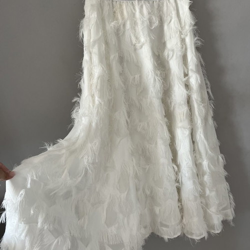 White maxi skirt with feathers and silver waistband