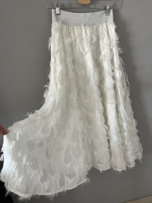 White maxi skirt with feathers and silver waistband