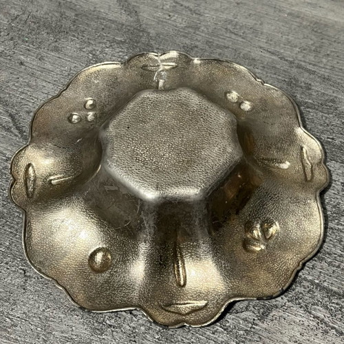 Decorative metal bowl used with embossed design