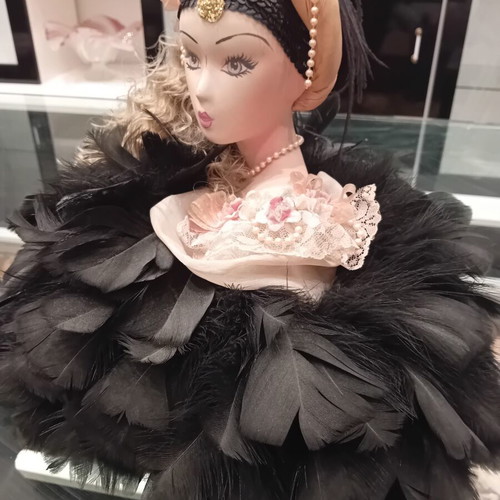 Vintage porcelain doll with feathers, handpainted, used
