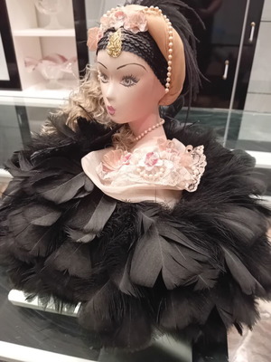 Vintage porcelain doll with feathers, handpainted, used