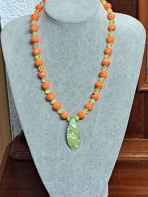 Long necklace with shell pendant, orange and green beads