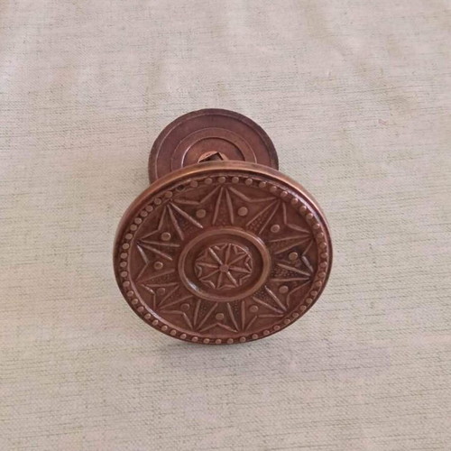 Bronze door knob used with geometric star pattern