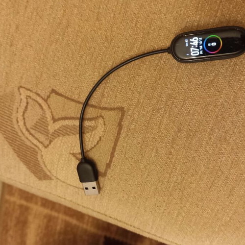 Mi Band smart watch used with charger, strap needs replacement