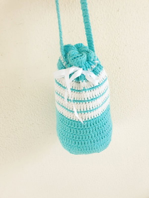 Handmade turquoise knitted pouch toiletry bag used