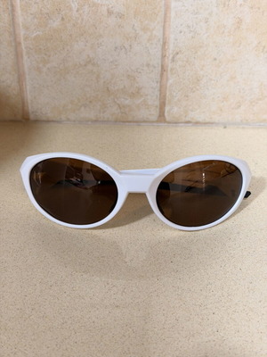 White cat-eye sunglasses with brown lenses