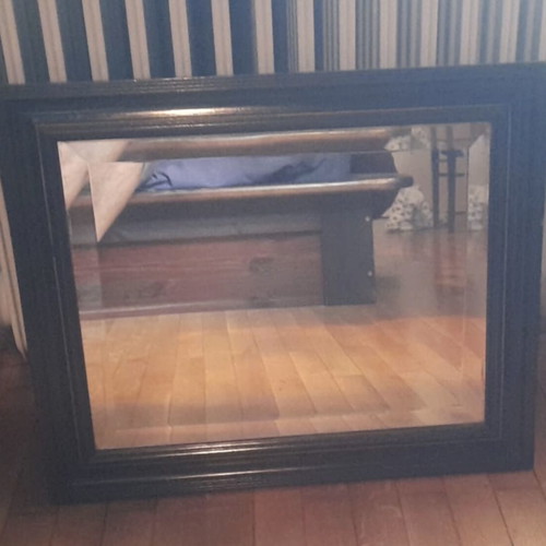 Large wall mirror used with wooden frame