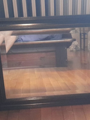 Large wall mirror used with wooden frame