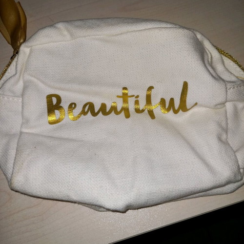 Swarovski and Clarins toiletry bags like new, set of 2 white