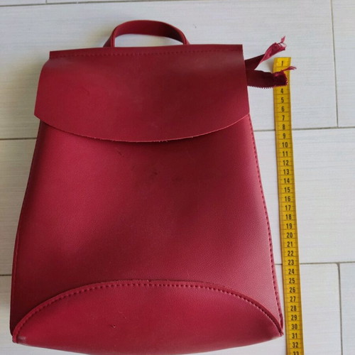 Red backpack used with broken zipper and mark