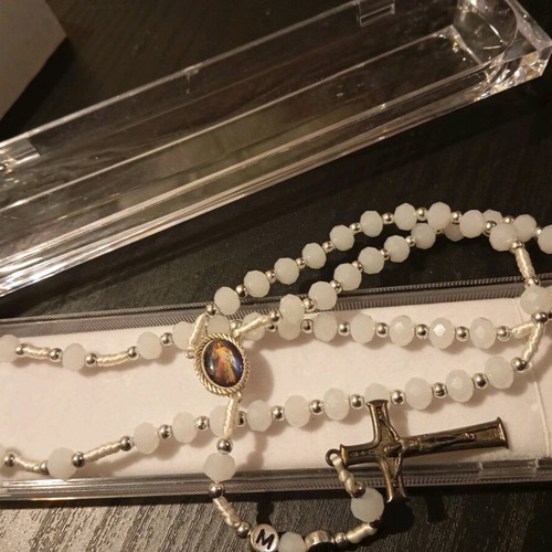 Old rosary in plexiglass case new