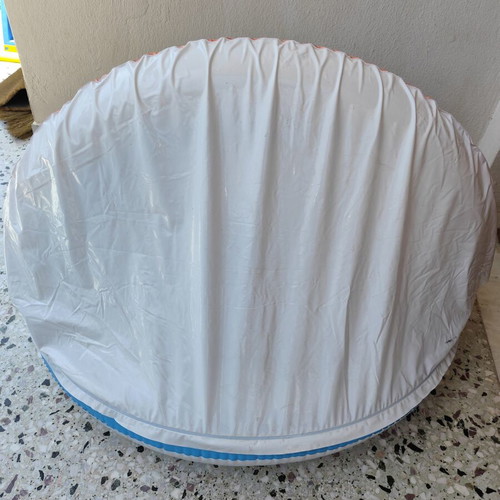 Blue children's pool with canopy used, rainbow design