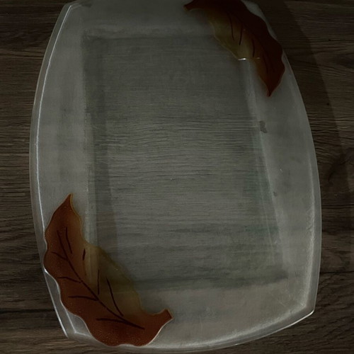 Decorative glass tray used with embossed leaf design
