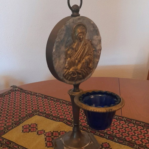 Bronze religious lamp used with embossed Virgin Mary image on stone base