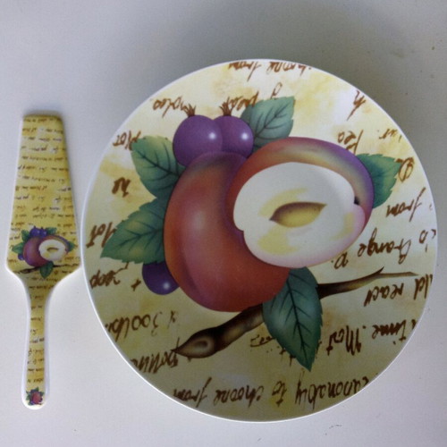 Ceramic serving platter with matching spatula, fruit design
