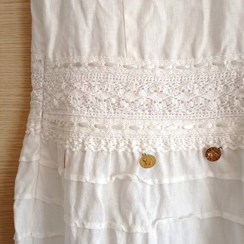 Long white dress used with lace and fake coins