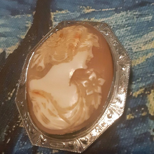 Vintage brooch like new with silver frame and carved bone relief
