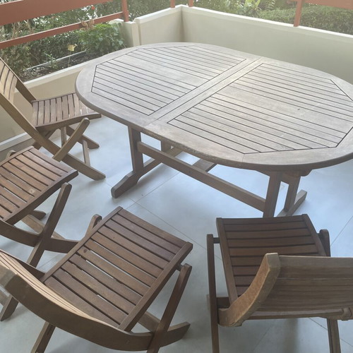 Wooden balcony table with four chairs used