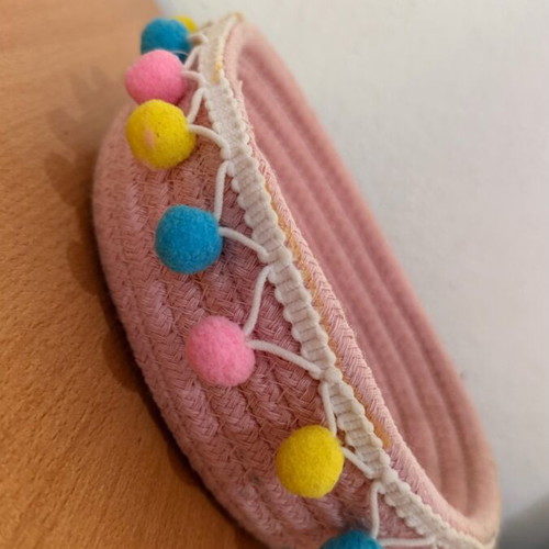 Handmade pink basket with colorful pom poms like new