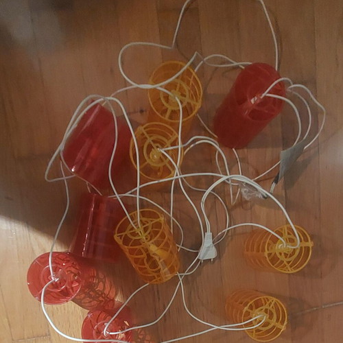 Outdoor balcony string lights used, red and orange