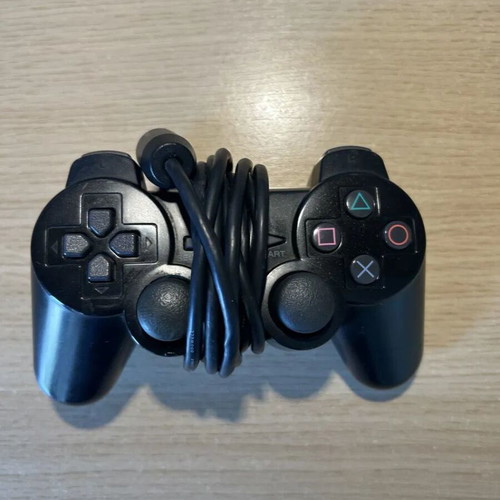 Sony PlayStation 2 Slim console used with DualShock 2 and cables