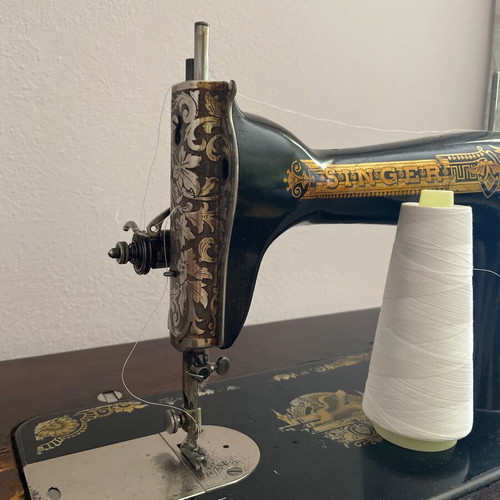 Singer 1960 foot-powered sewing machine used, wooden cover and table