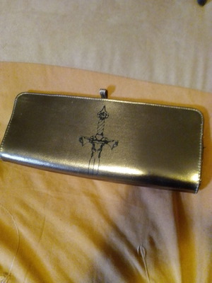 Bronze clutch bag with black design used