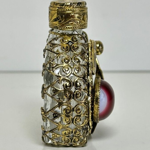 Vintage perfume flacon with filigree metalwork and red cabochon