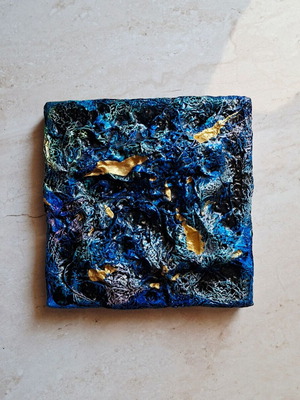 Abstract painting with blue and gold textured surface