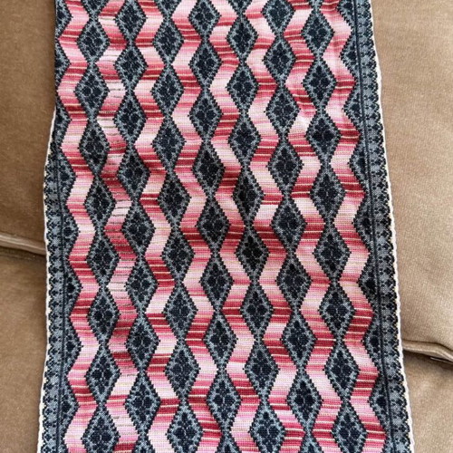 Handmade embroidered table runner with diamond pattern