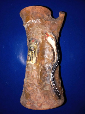 Ceramic vase used with tree trunk and snake design