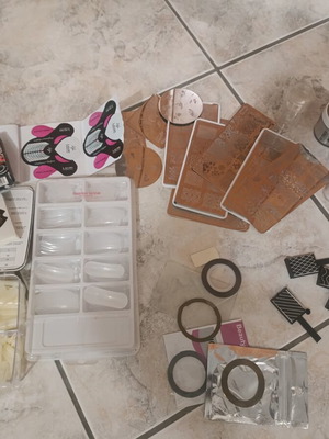 Nail art kit with tips, stamping plates and accessories