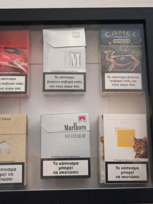 Frame with used collectible cigarette packs