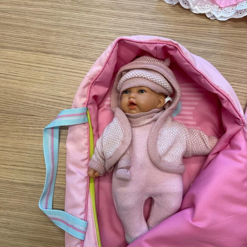 Baby doll like new vinyl with sleeping bag and knitted clothes