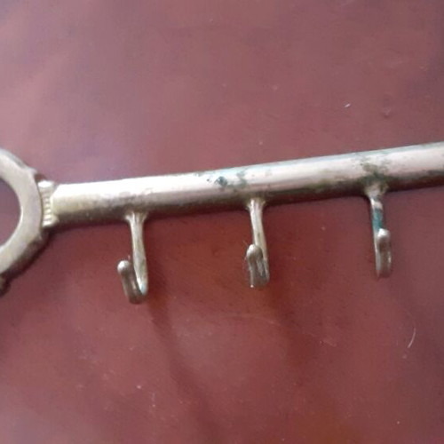 Vintage brass key-shaped hanger used, decorative wall hook