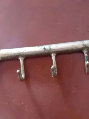 Vintage brass key-shaped hanger used, decorative wall hook