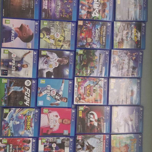 PlayStation 4 Slim 500GB used with 2 controllers and 33 games