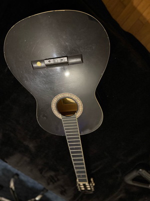 Classical guitar used, black, requires service and saddle