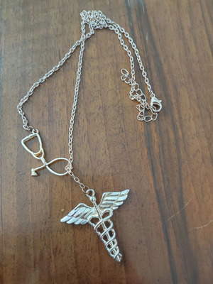 Health symbol necklace used, unworn
