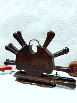 Wooden carved stand with used set of knives and forks