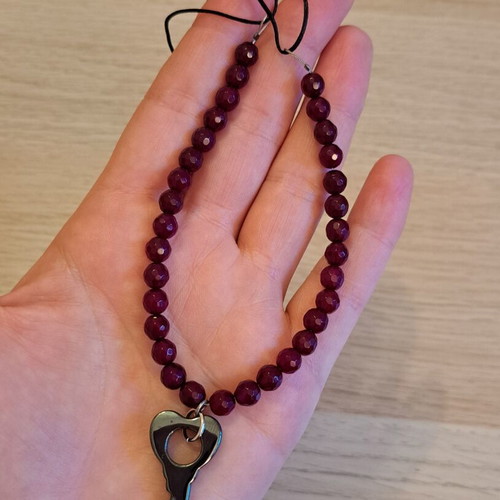 Necklace with black cord, burgundy polygonal beads and hematite key pendant like new