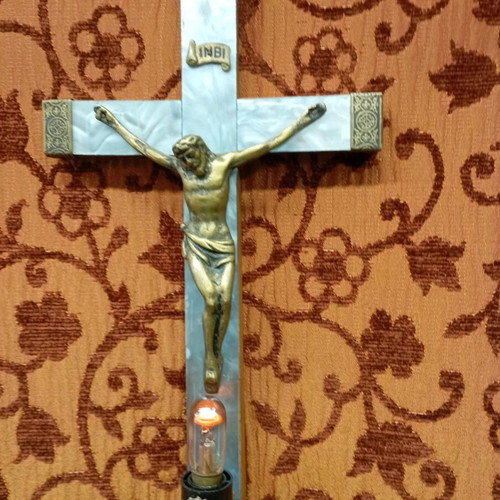 Old wooden crucifix used with bronze and light