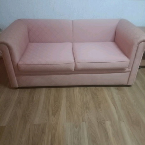Vintage two-seater sofa used, salmon color in very good condition