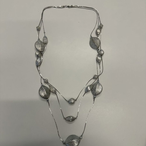 Triple necklace with silver pebble-like elements