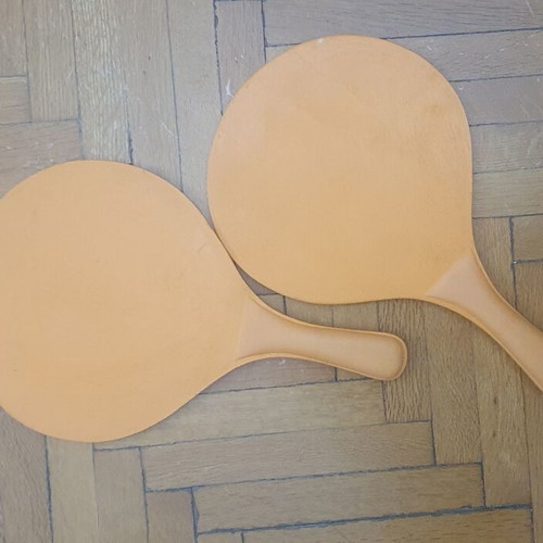 Wooden rounded beach paddles, orange