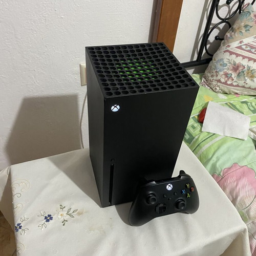 Xbox Series X console used with black wireless controller