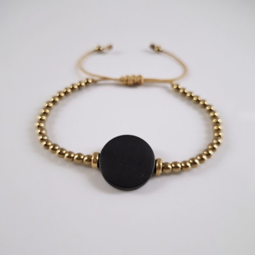 Bracelet with gold beads and black wooden adjustable element